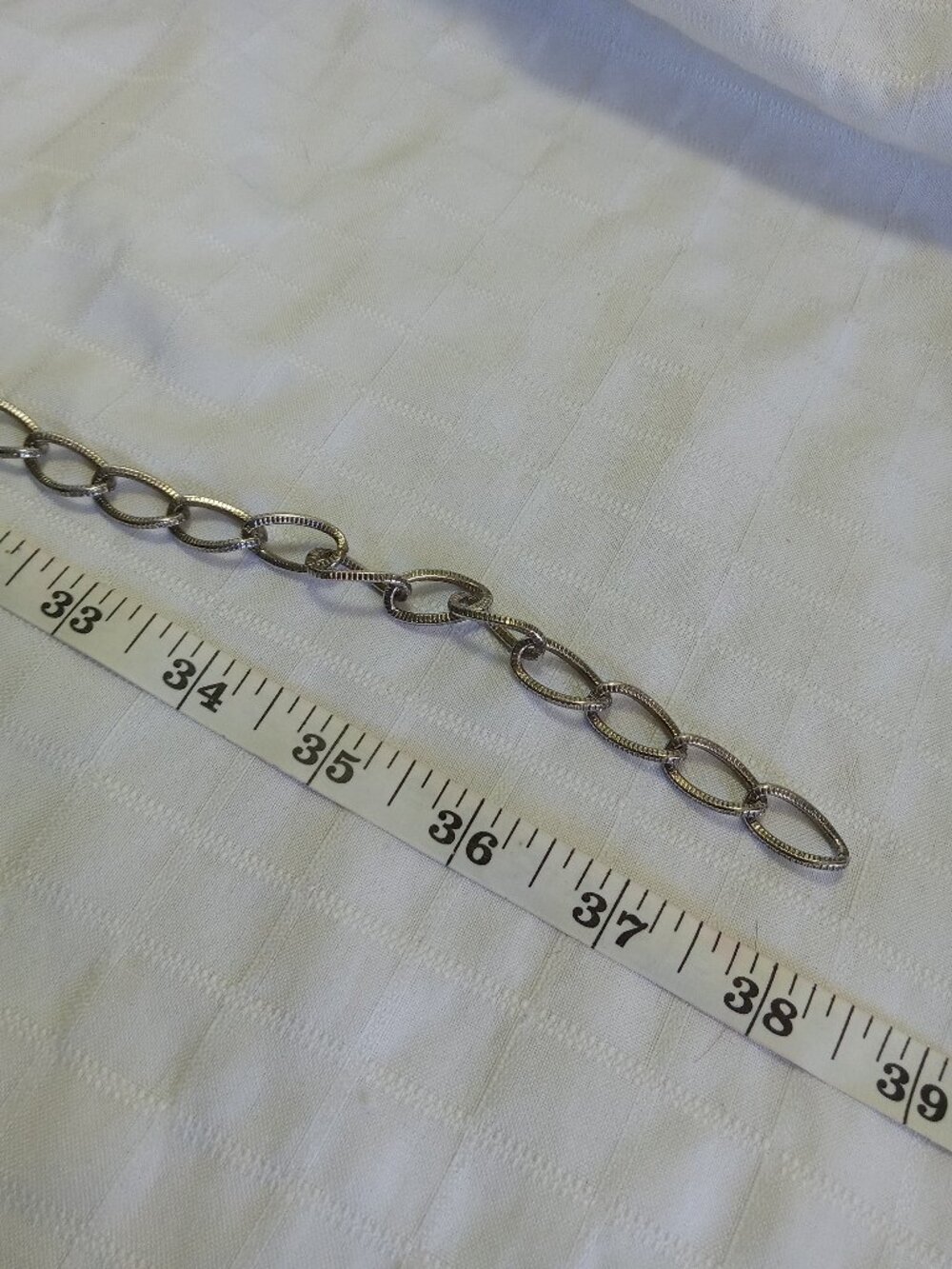 Vintage metal belt with many row and false money pieces in a silver color